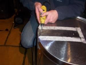 removing skin from mash tun base with dremmel