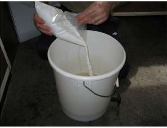 adding brewing sugar to the fermenter